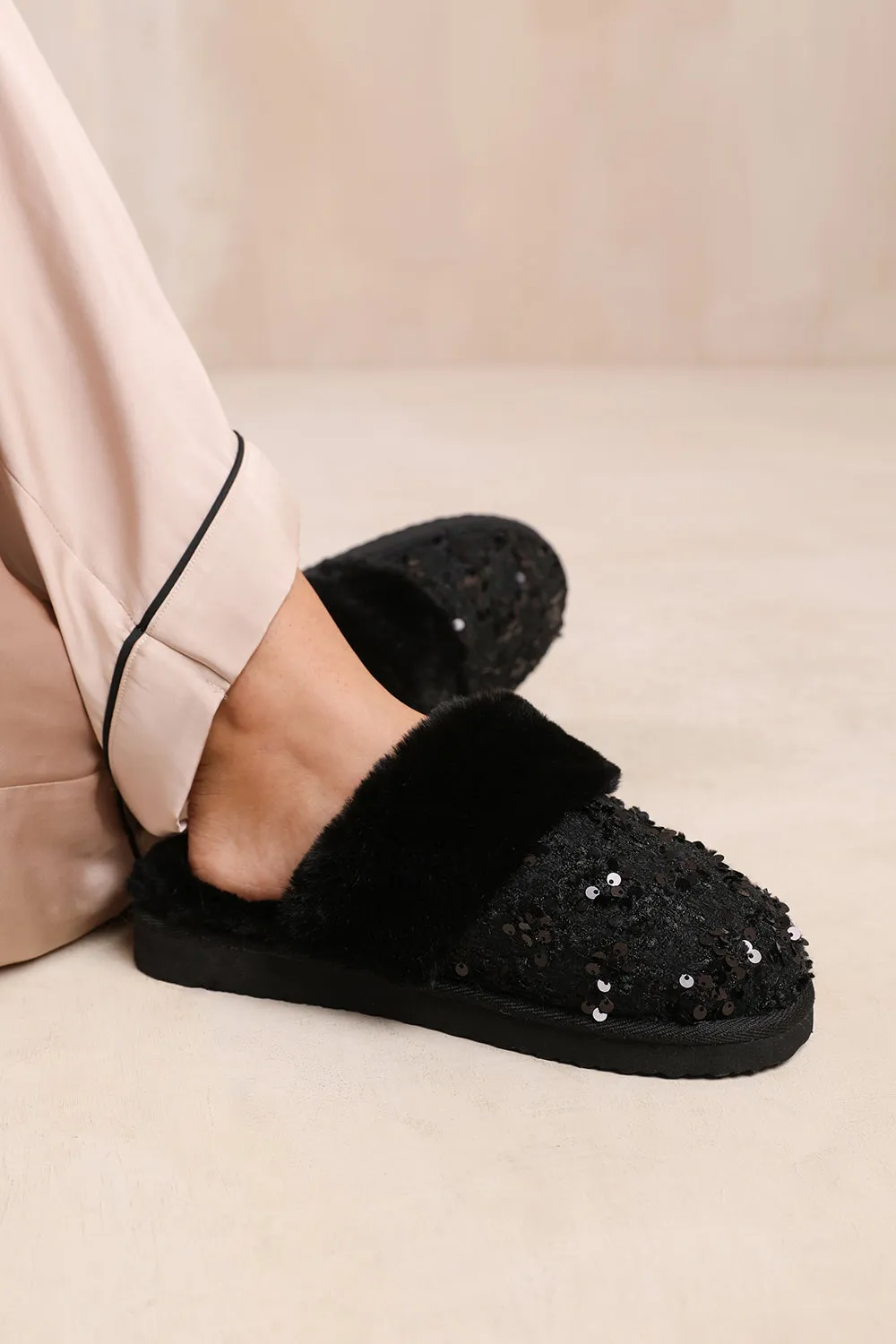 COZY SLIP ON SEQUIN SLIPPERS WITH FUR TRIM IN BLACK